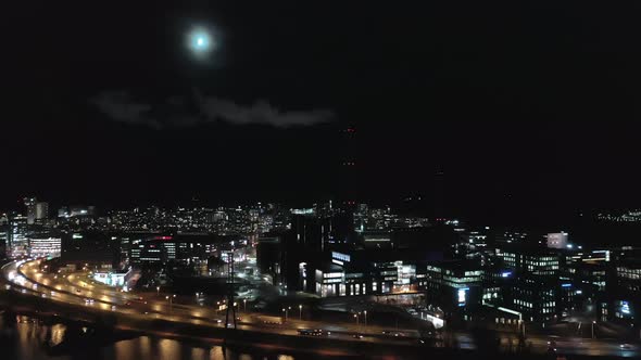 Drone Point of View of a Smoking Chimney in Helsinki on a Moonlit Night