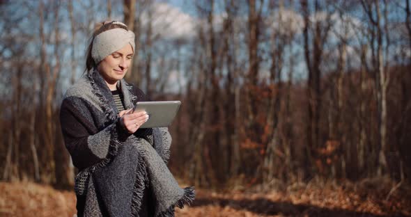 Woman Using Digital Tablet Outdoors on a Trip