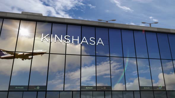 Airplane landing at Kinshasa Congo airport mirrored in terminal