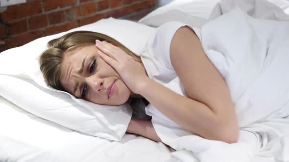 Upset Woman Crying in Bed at Night