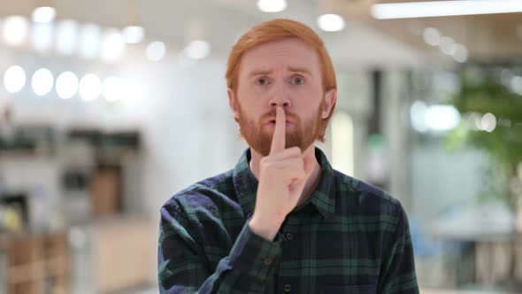 Portrait of Beard Redhead Man with Finger on Lips, Quiet Sign 