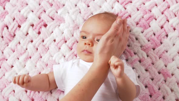 Sweet Baby Girl Lying on Knitted Plush Blanket
