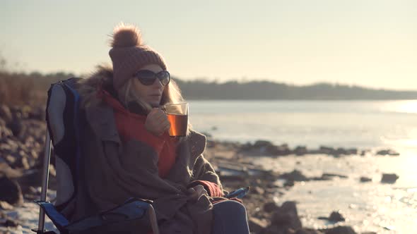 Traveler Enjoying Hot Tea In Mug On Forest Adventure. Refreshment From Thermos On Hiking At Cold.