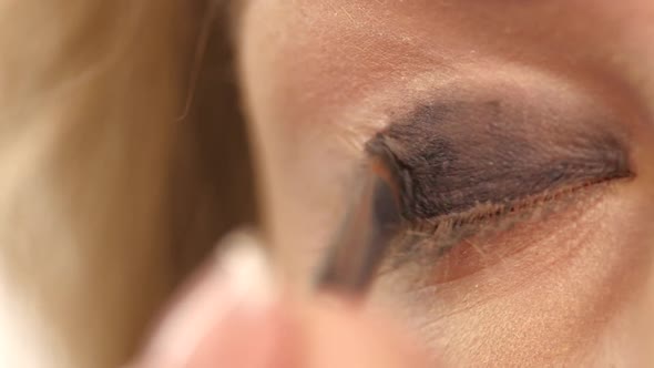 Woman Applying Eyeshadow Powder, Close Up. Slow Motion