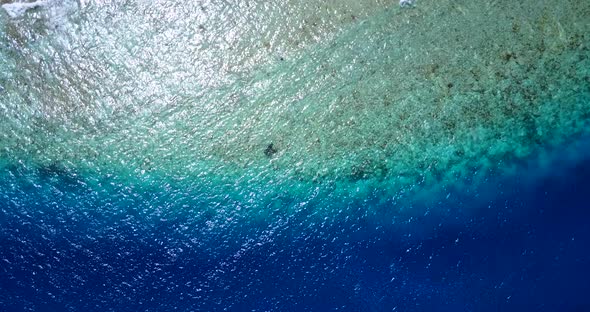 Beautiful birds eye clean view of a white paradise beach and aqua blue water background in best qual