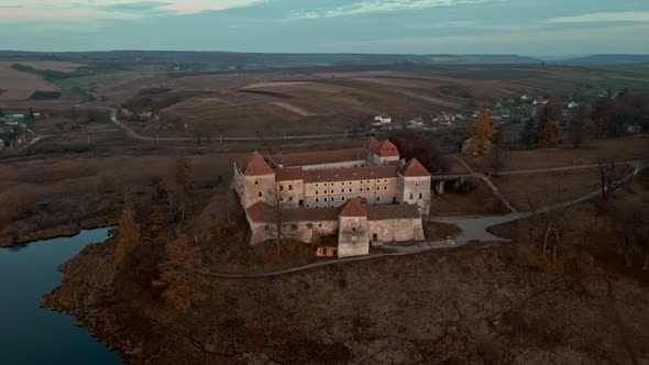 Aerial Drone Shot of Historic Castle on Hill Near Lake Medieval Architecture and Cultural Landmark