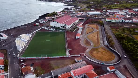 Aerial Footage of a Football ground and Race track at Madalena town in Pico Island, Azores. Portugal