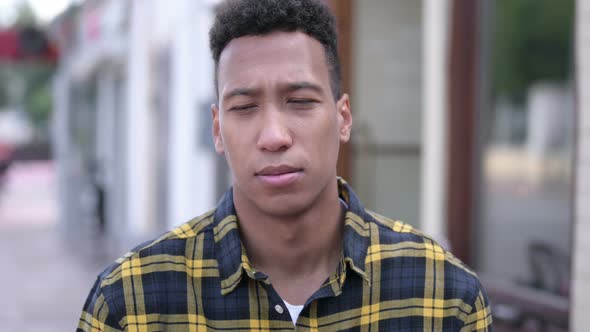 Outdoor Portrait of Upset Young African Man