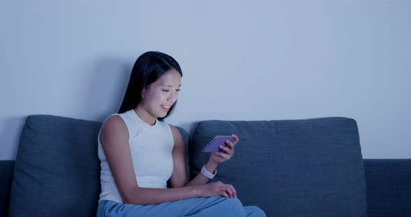 Woman Search on Smart Phone and Sit on Sofa at Home