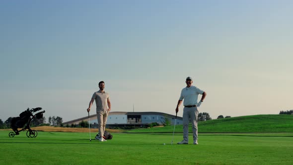 Two Men Enjoy Golf on Fairway Field Club