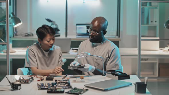 Diverse Lab Workers Discussing Computer Hardware