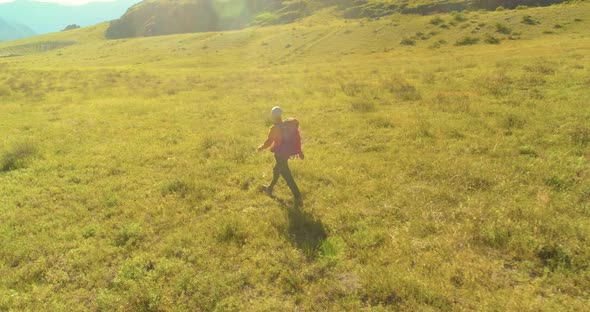 Flight Over Backpack Hiking Tourist Walking Across Green Mountain Field