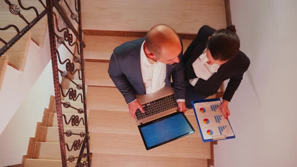 Top View of Businessman Holding Laptop Discussing