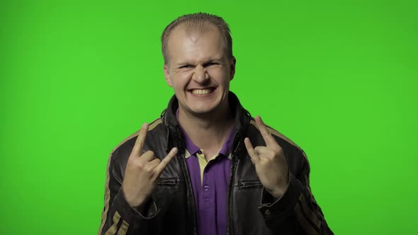 Rocker Man Showing Rock and Roll Sign, Devil Horns Gesture, Looking with Crazy Expression