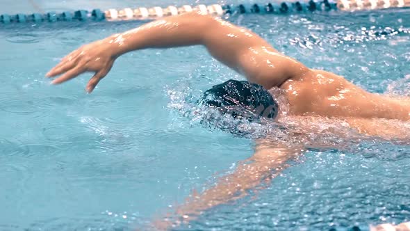 Muscular Professional Male Swimmer in Goggles Having Training Doing Crawl Stroke