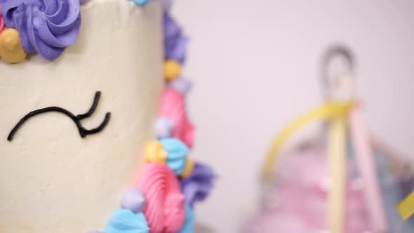Close up of little girl's birthday party table with unicorn cake, cupcakes, and sugar cookies.