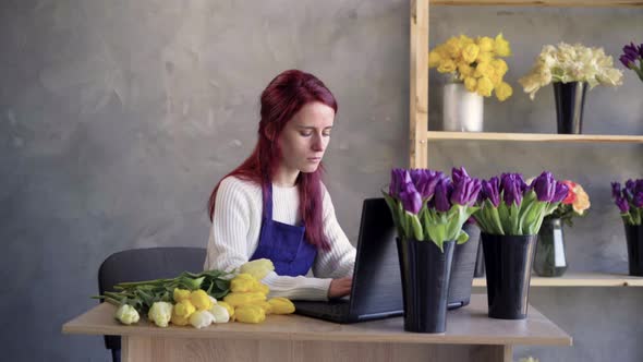 Female Entrepreneur Female Florist Working on Laptop Ordering Plants