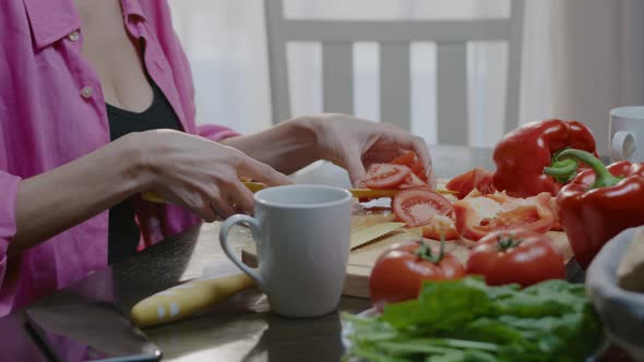 Woman hand preparing fresh salad at home. Family have dinner in the kitchen