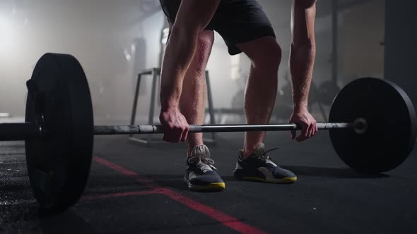 Slow Motion Male Powerlifter Preparing for Training in Gym