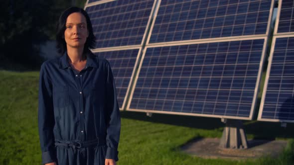 Woman Standing By the Solar Battery