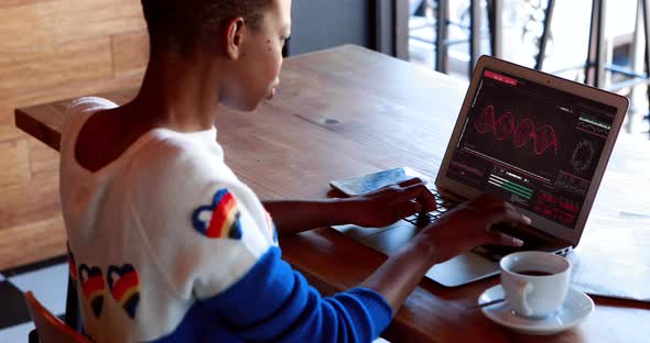 Female executive using laptop at desk