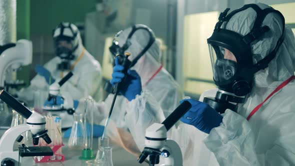 Virologists Work with Tubes and Pipettes While Creating a Coronavirus Vaccine. alt