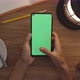 Top View Woman Uses Thumb Touch On Green Screen Of Smart Phone. Hobby Table Background. Chroma Key. - VideoHive Item for Sale