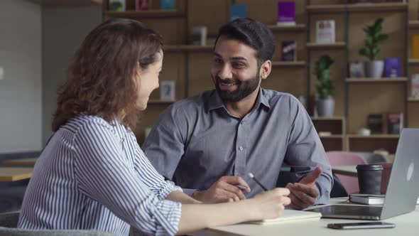 Two Happy Friendly Diverse Professional Employees Having Discussion at Work