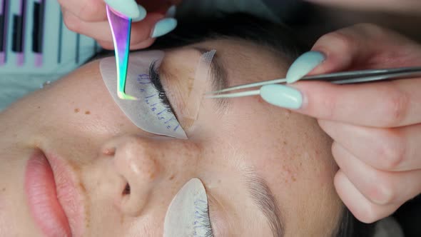 Eyelash Extension Master Straightens Client's Readymade Eyelashes with Tweezers