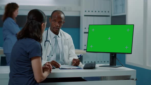 Male Doctor and Woman Using Green Screen on Computer