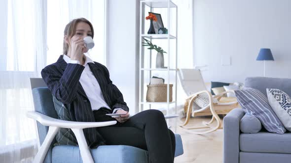 Pensive Woman Thinking and Drinking Coffee in Office