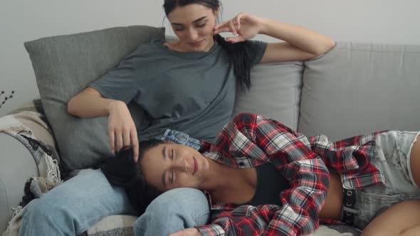 Happy Lesbian Couple in Love Cuddling Laughing Talking at Home
