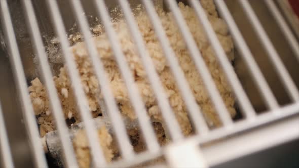 Man Using Pasta Machine to Prepare Dough for Tagliatelle Close Up View Modern Pasta Machine Kneaders