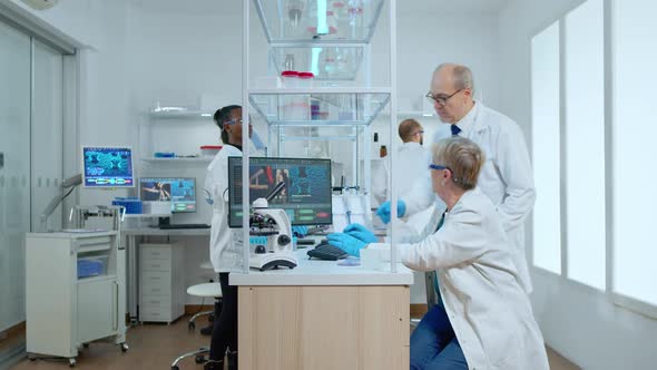 Team of Elderly Scientists Discussing About Vaccine Development