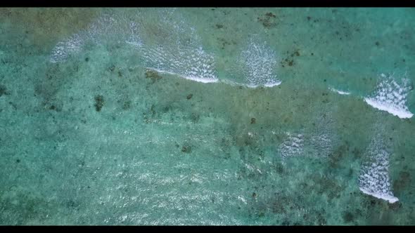 Aerial above abstract of relaxing shore beach voyage by aqua blue sea and white sandy background of 