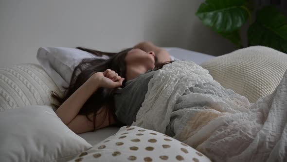 young woman girl on the bed at home, sleepy relaxing in the morning on pillow