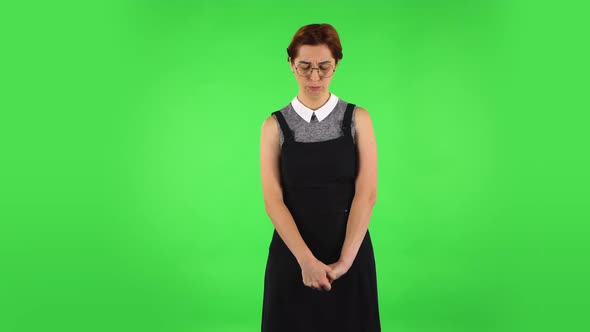 Funny Girl in Round Glasses Is Very Offended and Looking Away Then Smiling, Green Screen