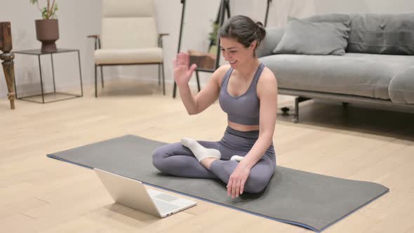 Indian Woman Talking on Video Call on Laptop on Yoga Mat