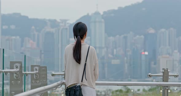 Woman look at the view of Hong Kong