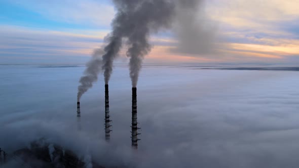 Coal Power Plant High Pipes with Black Smoke Moving Upwards Polluting Atmosphere