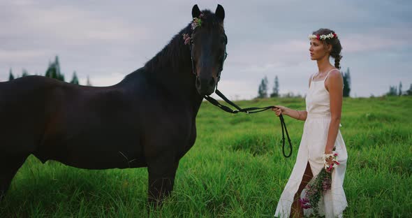 Beautiful bohemian woman standing with horse