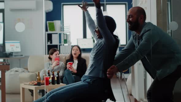 Man and African American Woman Having Fun at Office After Work