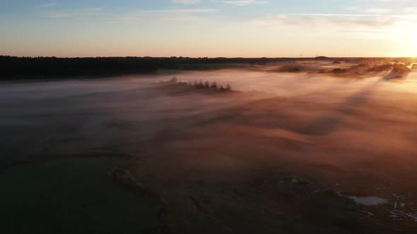 Drone View of Heavenly Skies During Sunrise and Foggy Horizon