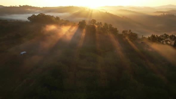 4K Aerial view from drone over mountains fog. Golden scenery at sunrise, Nan, Thailand