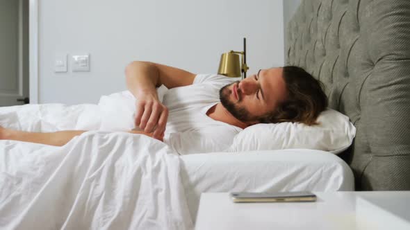 Man checking his mobile phone in bedroom
