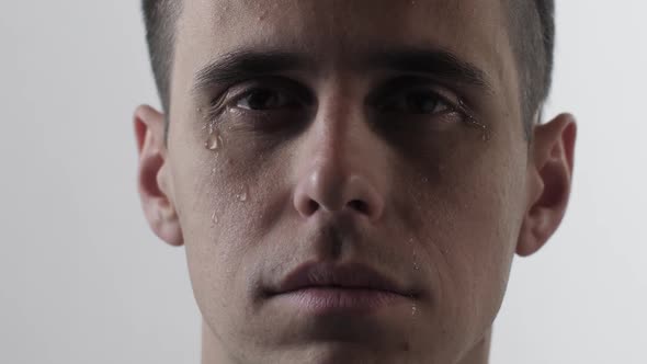 Young Man Crying on White Background