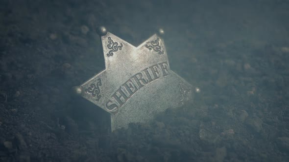 Wild West Sheriff Badge On Ground With Smoke
