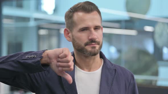 Middle Aged Businessman Showing Thumbs Down Gesture