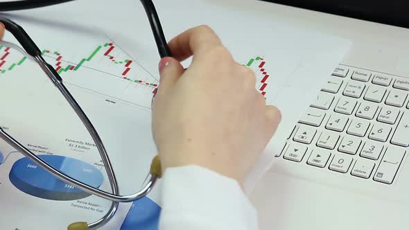 Tired Physician Taking Off Glasses and Stethoscope, Having Break After Long Day