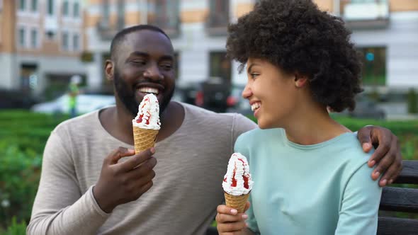 Dating Couple Eating Ice-Cream, Sitting on City Bench, Having Fun Together, Love